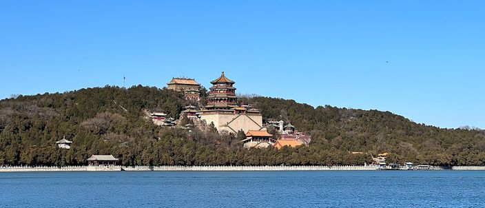 The Summer Palace seen across Kunming Lake: Longevity Hill rising from the water with the Tower of Buddhist Incense on its slope, under a clear winter sky