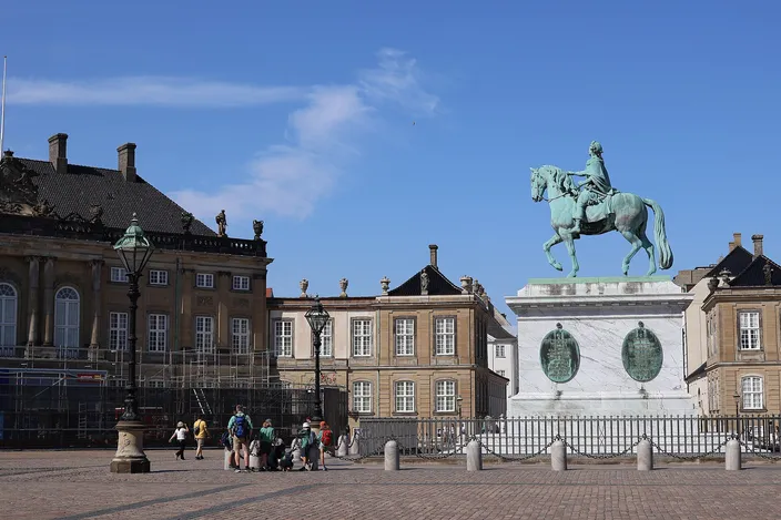 Amalienborg's cobbled octagonal square with the green bronze equestrian statue of Frederik V in front of one of the four palaces