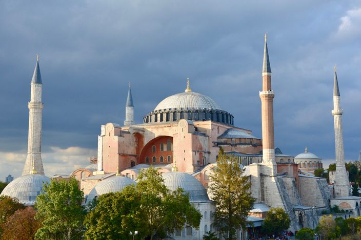 Hagia Sophia from the south-east under a heavy sky, its dome and half-domes stepping down between four minarets