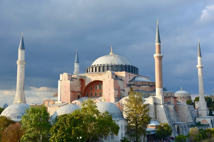 Hagia Sophia from the south-east under a heavy sky, its dome and half-domes stepping down between four minarets
