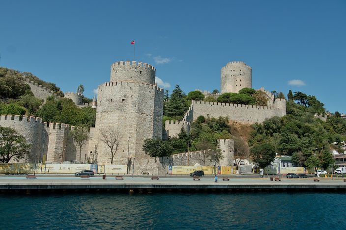 Rumeli Hisarı's towers and curtain walls rising from the Bosphorus shore, the strait narrow in front of them