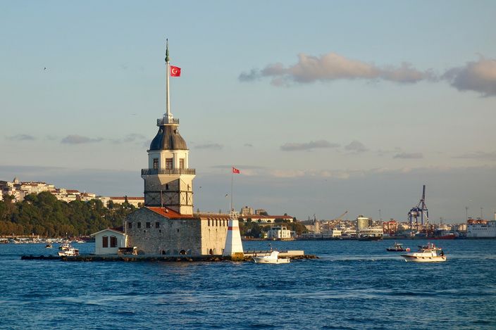 The Maiden's Tower on its small island in the Bosphorus, boats passing on either side and the city low on the far shore