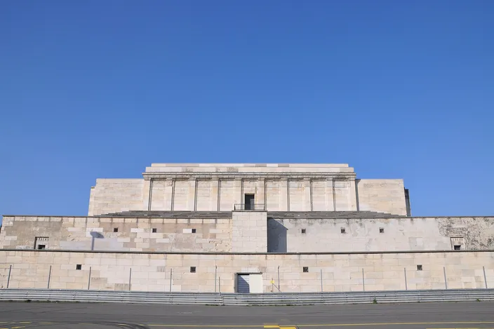The long, pale stone Zeppelin tribune on Nuremberg's former Nazi party rally grounds, stripped of its colonnade, under a clear blue sky