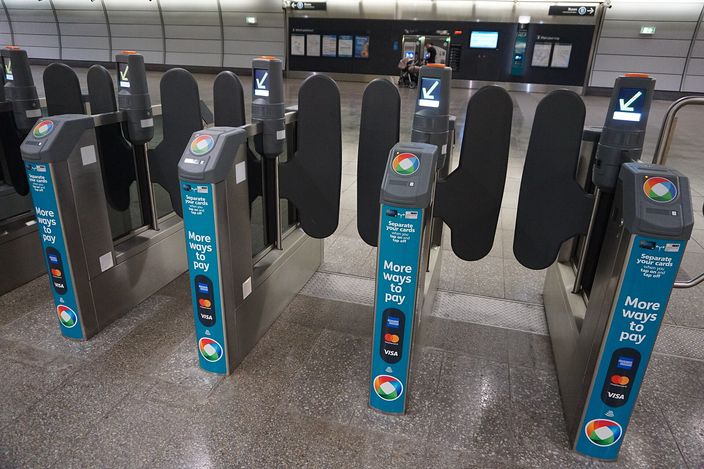 Opal card fare gates at a Sydney Metro station, each with 'More ways to pay' signage showing contactless and Opal tap readers, an empty concourse behind
